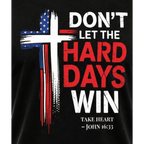 Close-up of patriotic cross graphic on black Don't Let the Hard Days Win Tee Christian t-shirt featuring John 16:33 scripture reference