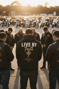 Lifestyle mockup of black Christian biker hoodie featuring “Live By Faith” back print design during motorcycle group prayer gathering at sunset.