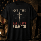 Patriotic faith-based graphic tee with distressed cross displayed beside lantern, Bible, and American flag