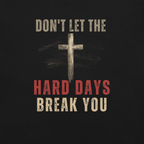 Close-up of distressed cross graphic on Don’t Let the Hard Days Break You black faith-based t-shirt