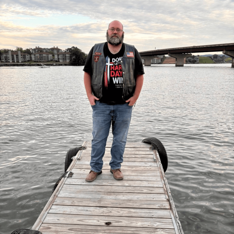 Shane, founder of Held & Anchored, wearing the Don't Let the Hard Days Win Tee — John 16:33 faith apparel