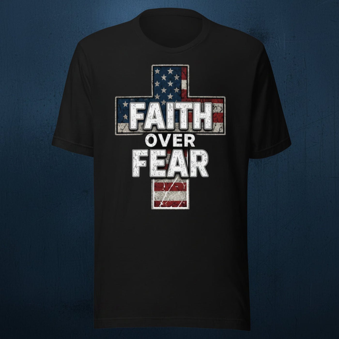 Black t-shirt featuring a distressed American flag cross design with bold “Faith Over Fear” lettering in white over a weathered patriotic cross graphic on a dark textured blue background.