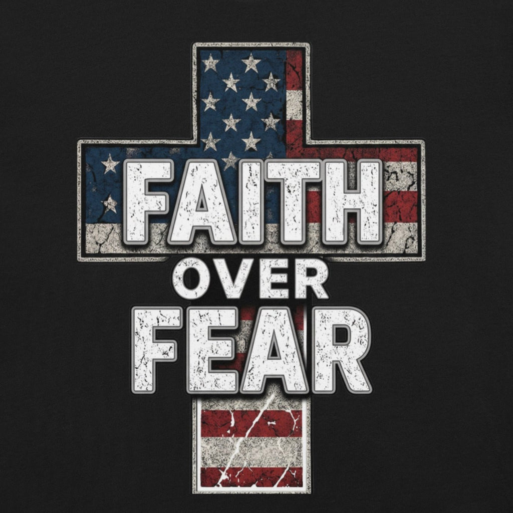 Black t-shirt mockup featuring a distressed American flag cross design with bold white “Faith Over Fear” lettering layered over a weathered patriotic cross graphic in red, white, and blue.