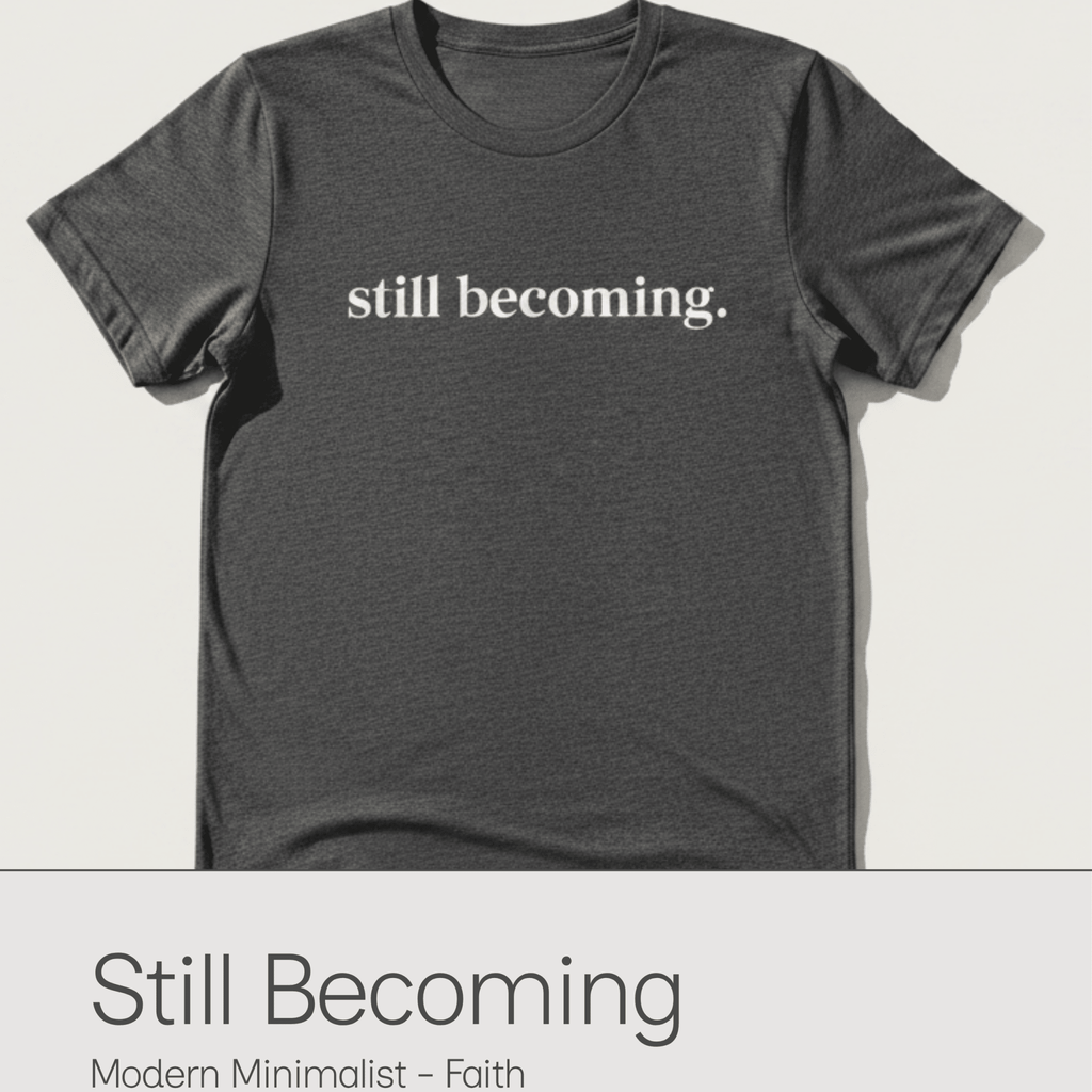 Gray t-shirt with 'still becoming' text on a white background