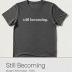 Gray t-shirt with 'still becoming' text on a white background