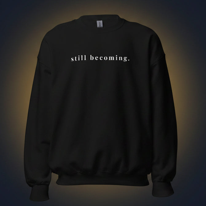 Black sweatshirt with a small logo on the chest against a contrasting background. 
